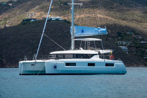 A Lagoon 46 sailing with the Navigare logo