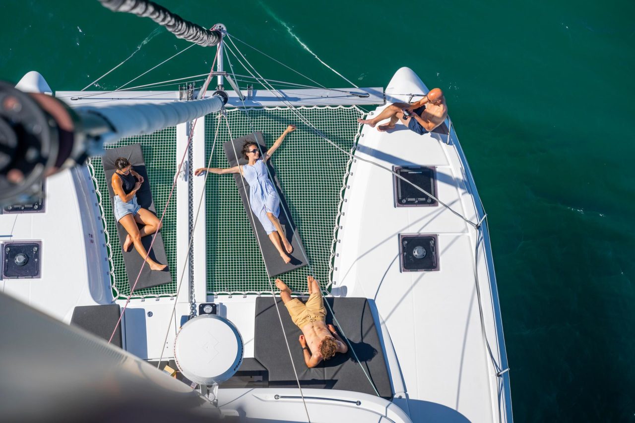 Lagoon 43 at anchor with guests practicing stand-up paddle