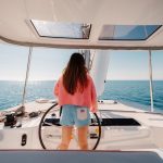 Woman at the helm of the Lagoon 46 Iconic sailing catamaran