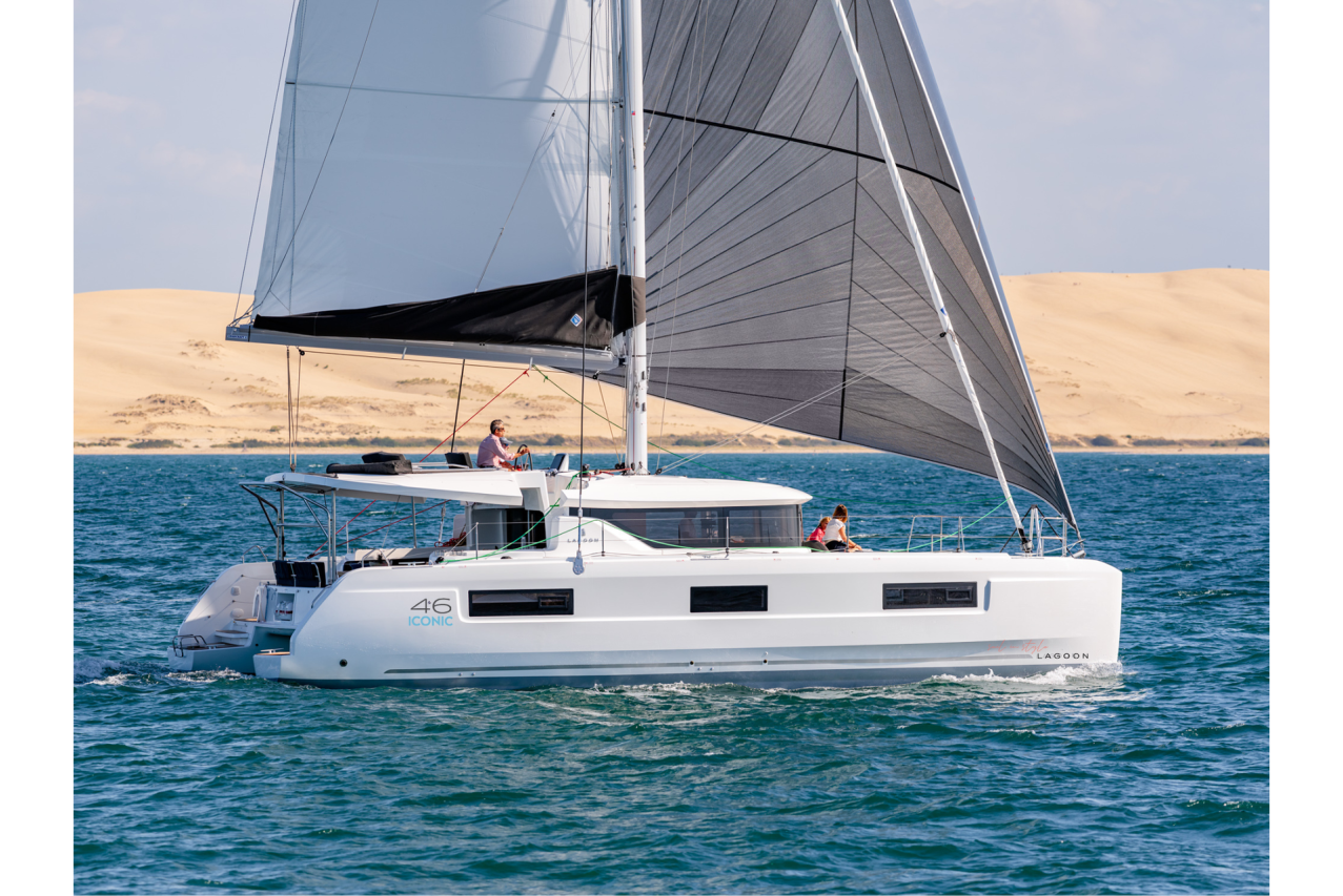 Lagoon 46 Iconic sailing with a man at the helm and children enjoying the foredeck