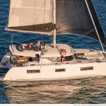 Lagoon 46 sailing with a family enjoying the flybridge