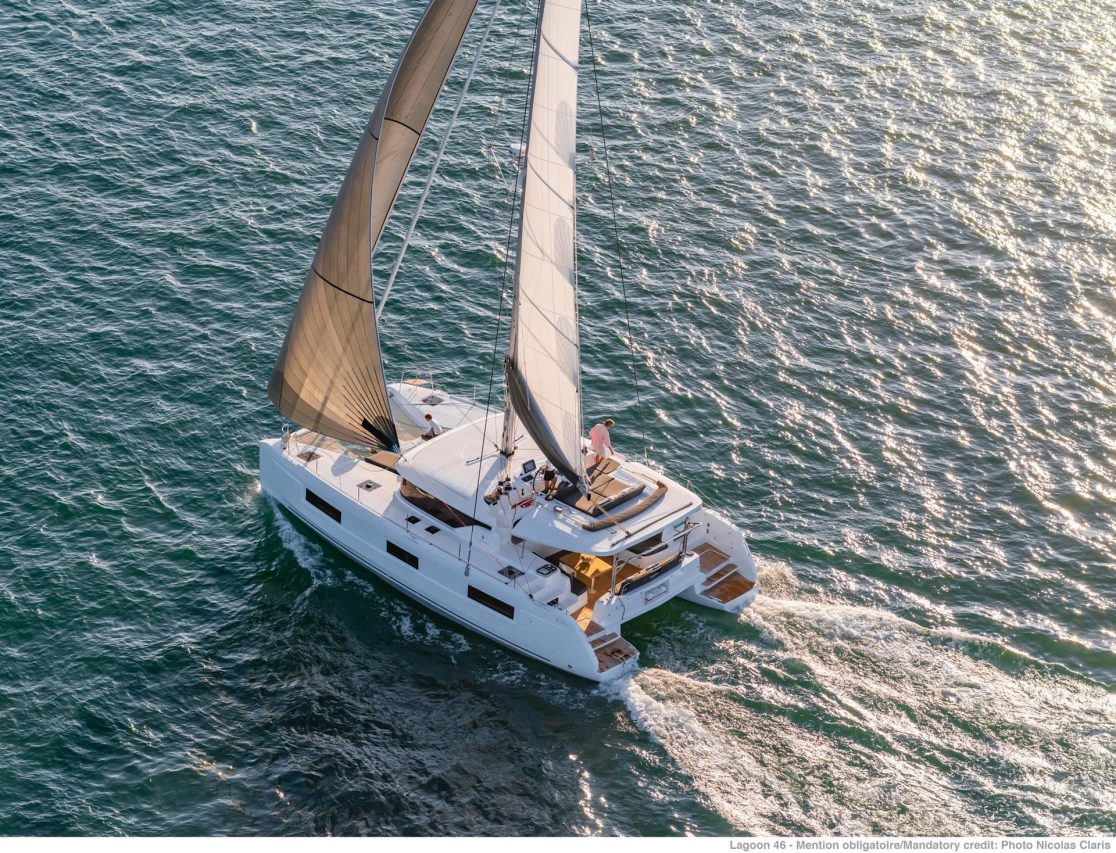 Lagoon 46 sailing with a man on the flybridge and a child on the foredeck