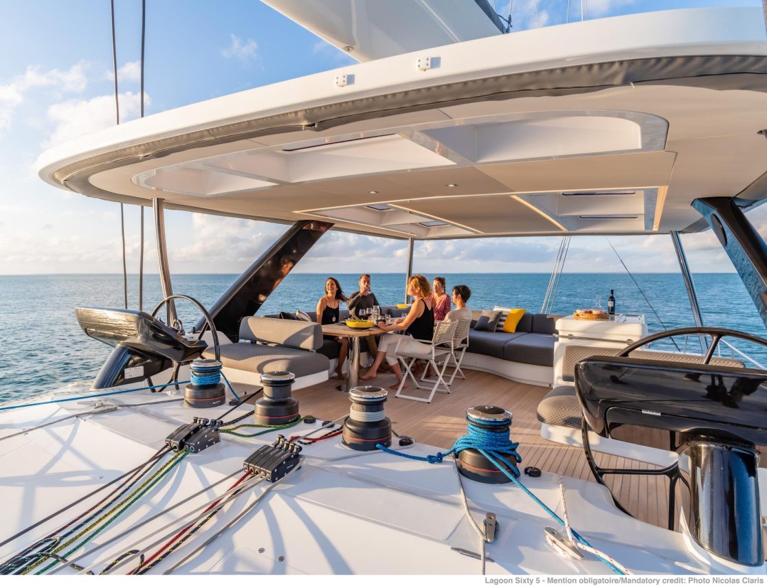Guests having lunch on the amazing flybridge of the Lagoon Sixty 5 with a beautiful view
