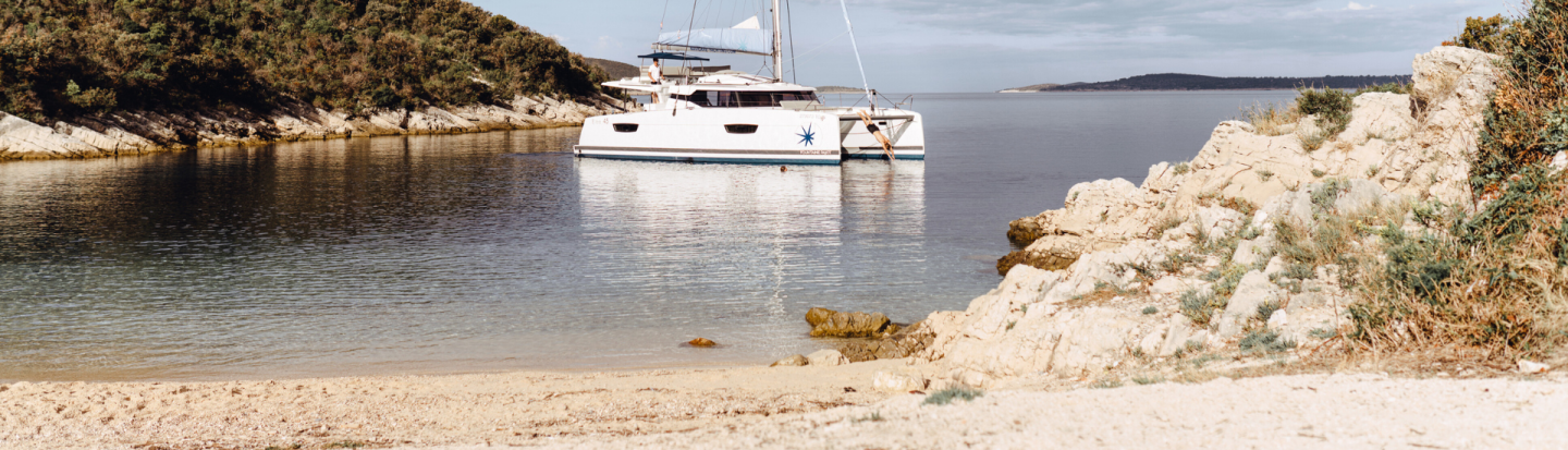 Man diving from an anchored yacht in a Mediterranean bay