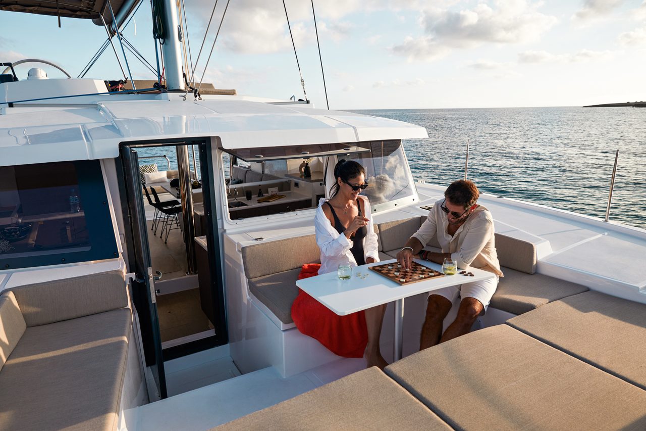 Couple having fun and drinking on the Bali 4.2 spacious foredeck