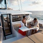 Couple having fun and drinking on the Bali 4.2 spacious foredeck
