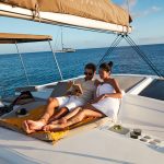 Couple reading a book on the cozy flybridge of the Bali 4.2 sailing catamaran