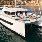 Bali 4.6 at anchor with guests enjoying the comfortable foredeck