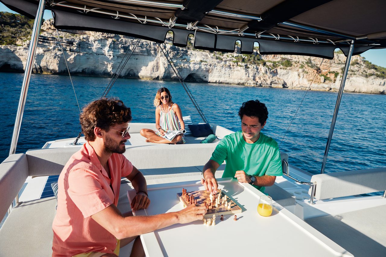 Guests playing chess on the Bali 4.6 spacious flybridge