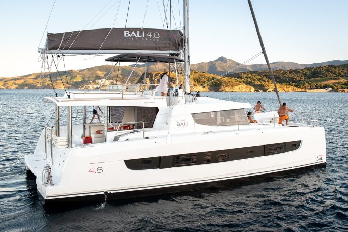 A Bali catamaran at anchor with people on board, enjoying the boat