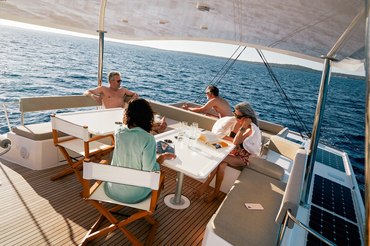Guest having a drink on the cozy flybridge of the Bali 5.4 sailing catamaran