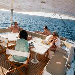 Guest having a drink on the cozy flybridge of the Bali 5.4 sailing catamaran