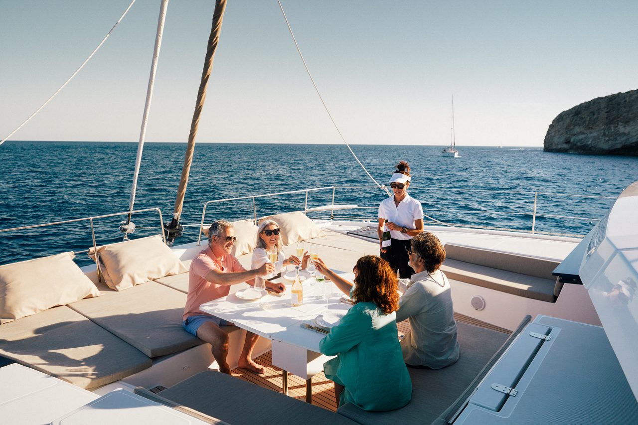 Guest having a drink on the comfy foredeck of the Bali 5.4 sailing catamaran