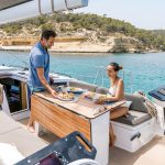Couple having a lunch in the comfortable cockpit of the Dufour 41 sailing monohull