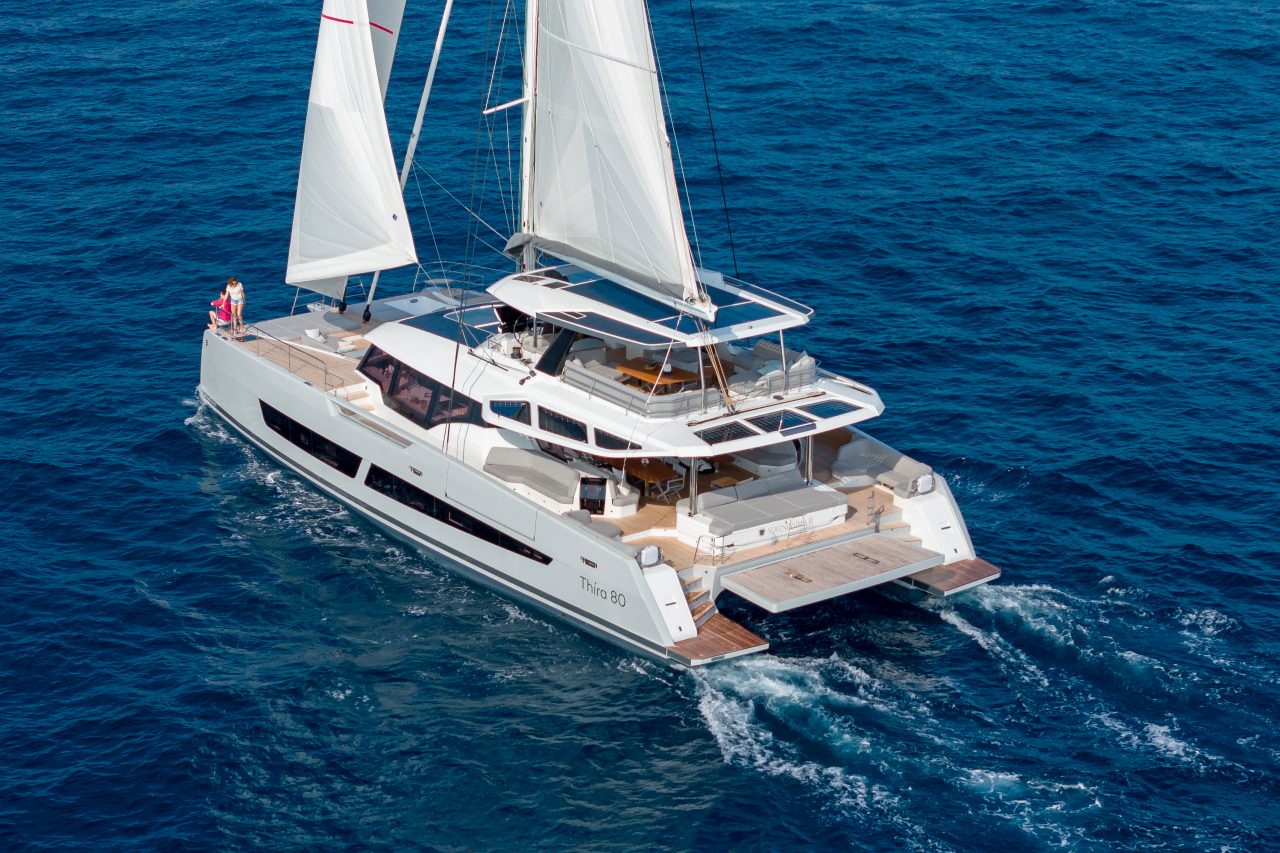 Fountaine Pajot Thira 80 sailing with a couple on the foredeck