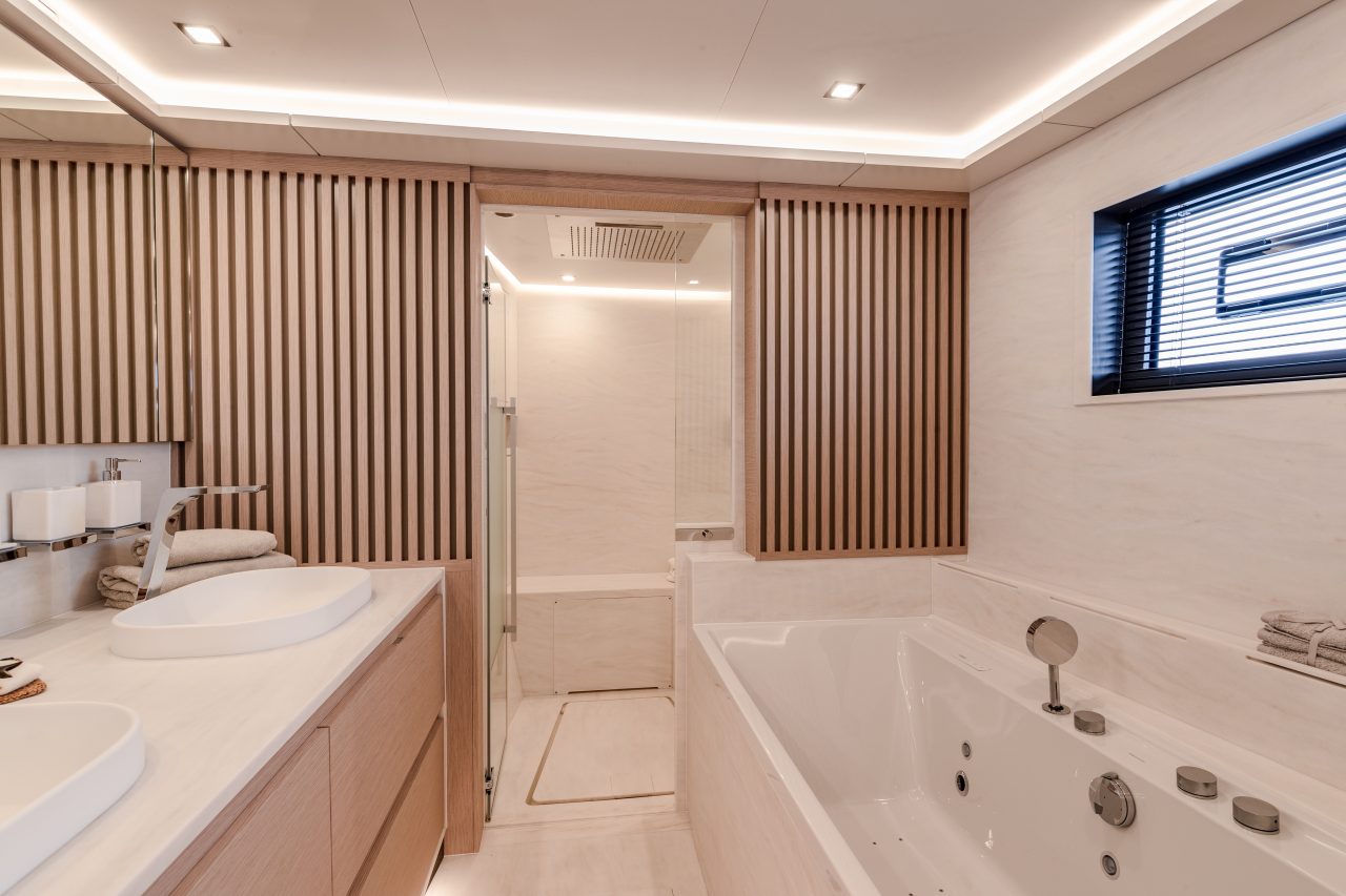 Large bathroom of a suite aboard the Fountaine Pajot Thira 80 sailing catamaran
