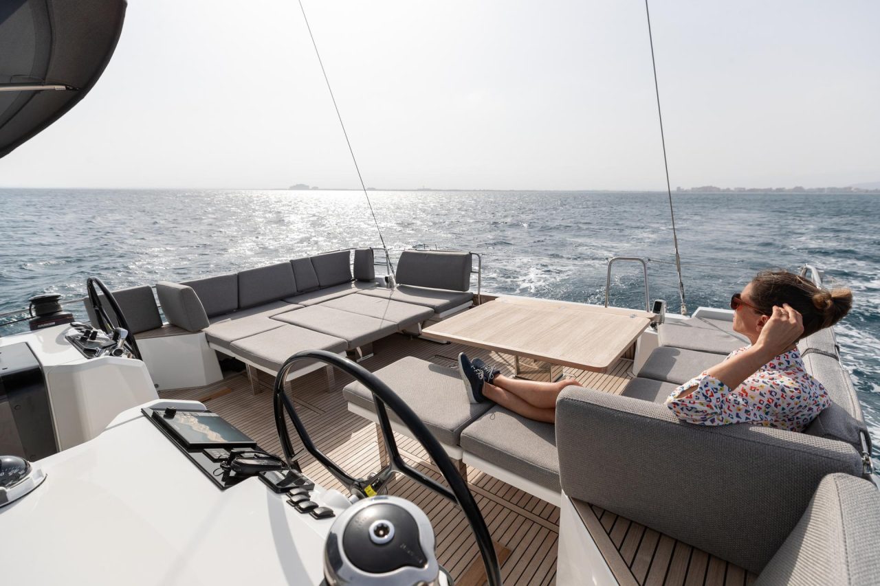 Woman enjoying the cockpit of the Jeanneau 55 sailing monohull