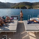 Guests enjoying cockpit benches and swimming deck on the Jeanneau 55 sailing monohull