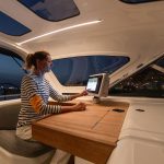 A woman in the helm station of the Jeanneau 55 sailing monohull