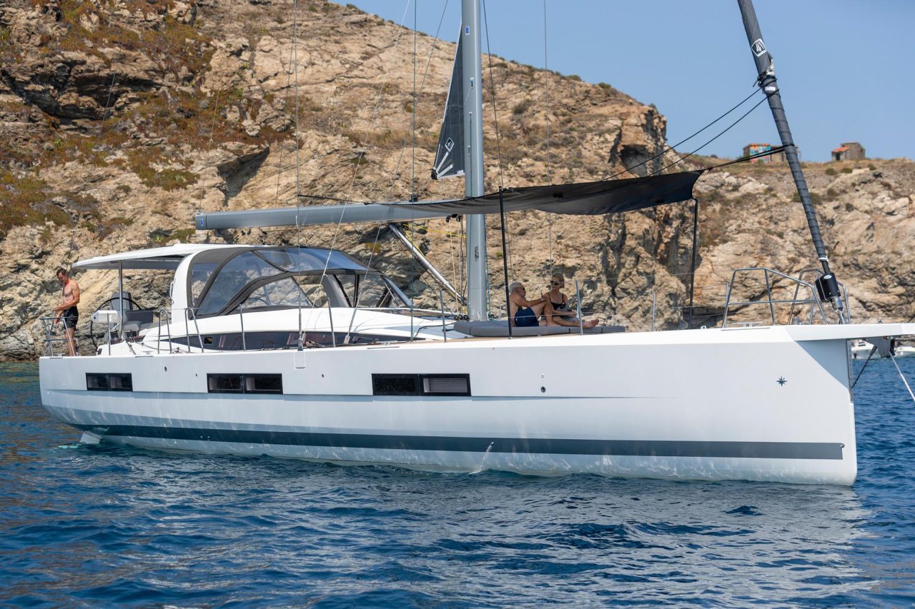 Jeanneau Yacht 60 at anchor with guests enjoying swimming deck and foredeck