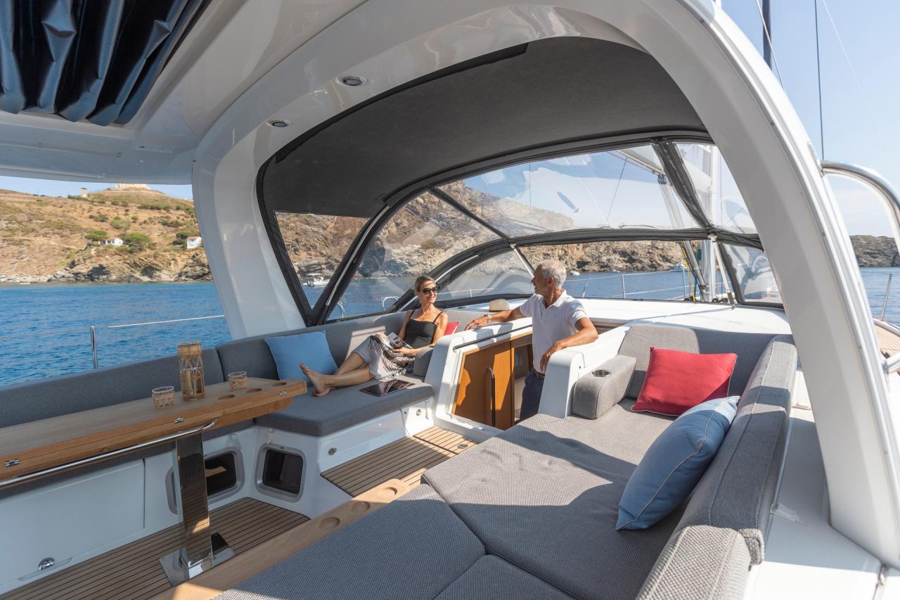 A man and a woman talking in the cockpit of the Jeanneau Yacht 60 sailing monohull