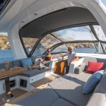 A man and a woman talking in the cockpit of the Jeanneau Yacht 60 sailing monohull