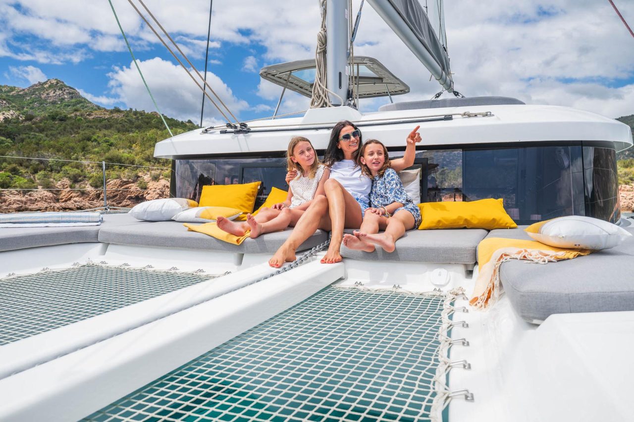 Family enjoying the spacious foredeck of the Lagoon 38 sailing catamaran