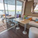 Through view of the spacious salon and cockpit of the Lagoon 38 sailing catamaran