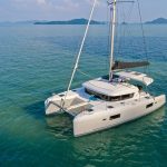 Lagoon 42 Millennium sailing catamaran at anchor near the Asian cliffs
