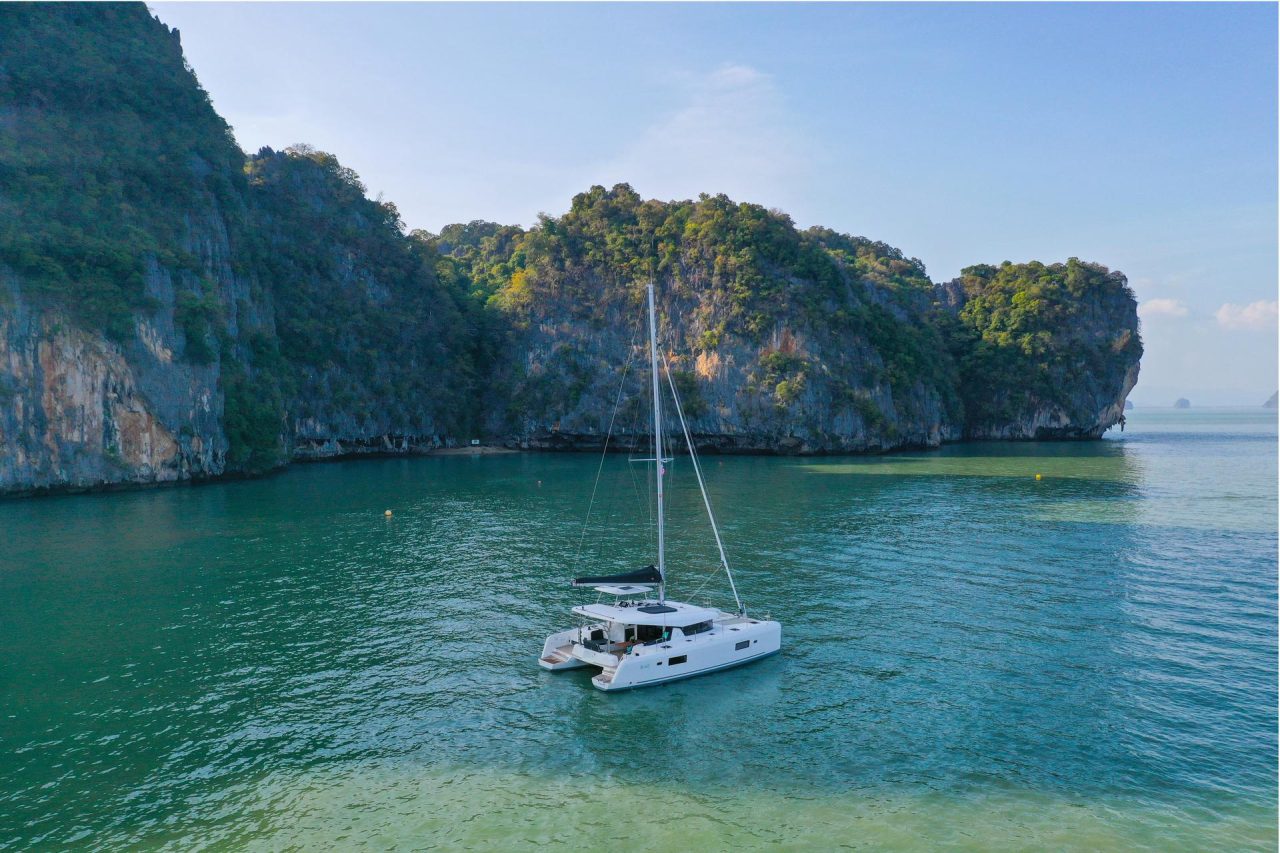 Lagoon 42 Millennium sailing near the Asian cliffs