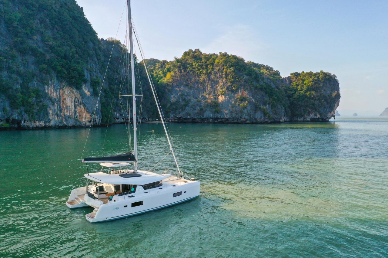 Lagoon 42 Millennium sailing near the Asian cliffs