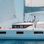 Lagoon 46 Iconic sailing with a man at the helm and women enjoying the foredeck