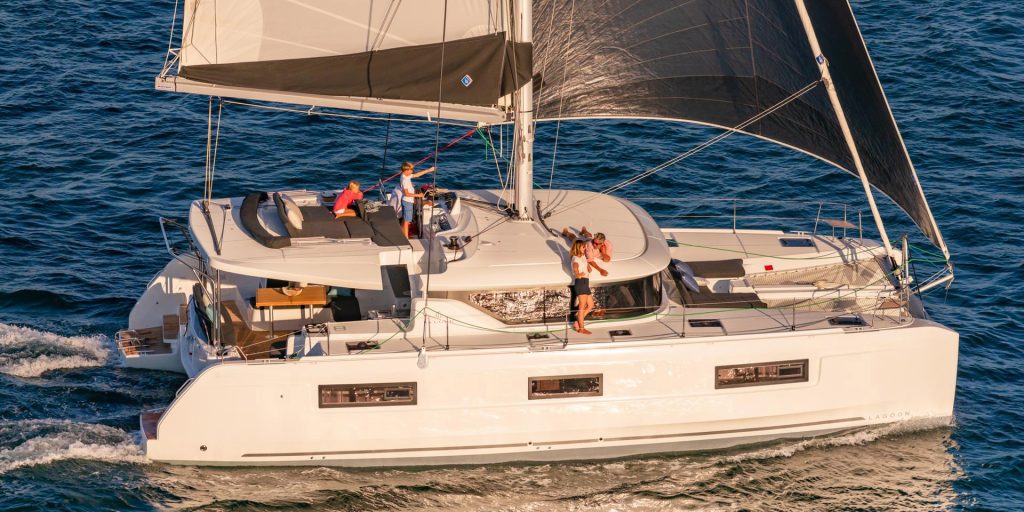 Lagoon 46 sailing with a family enjoying the flybridge