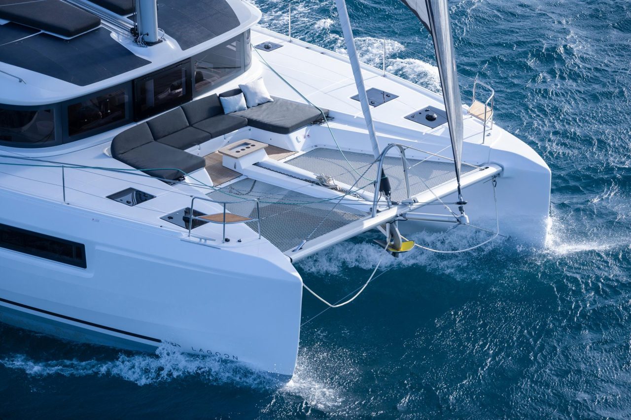 Lagoon 46 Iconic sailing with a man at the helm and children enjoying the foredeck