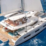 Women taking sun on the comfortable foredeck of the Lagoon 55 sailing catamaran