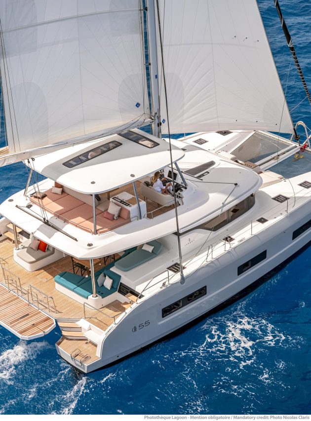 Women taking sun on the comfortable foredeck of the Lagoon 55 sailing catamaran
