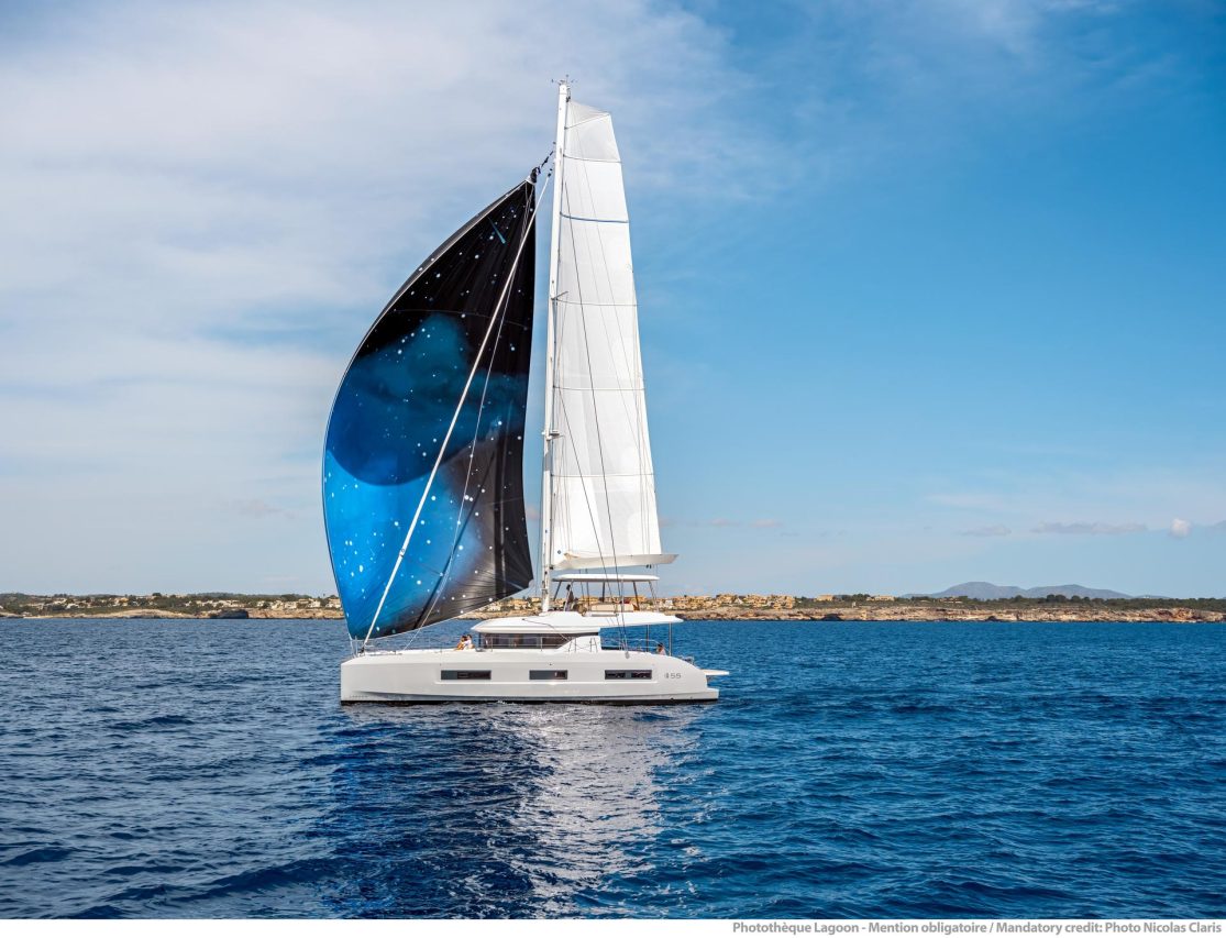Lagoon 55 sailing with a man at the helm and women enjoying the flybridge and the cockpit