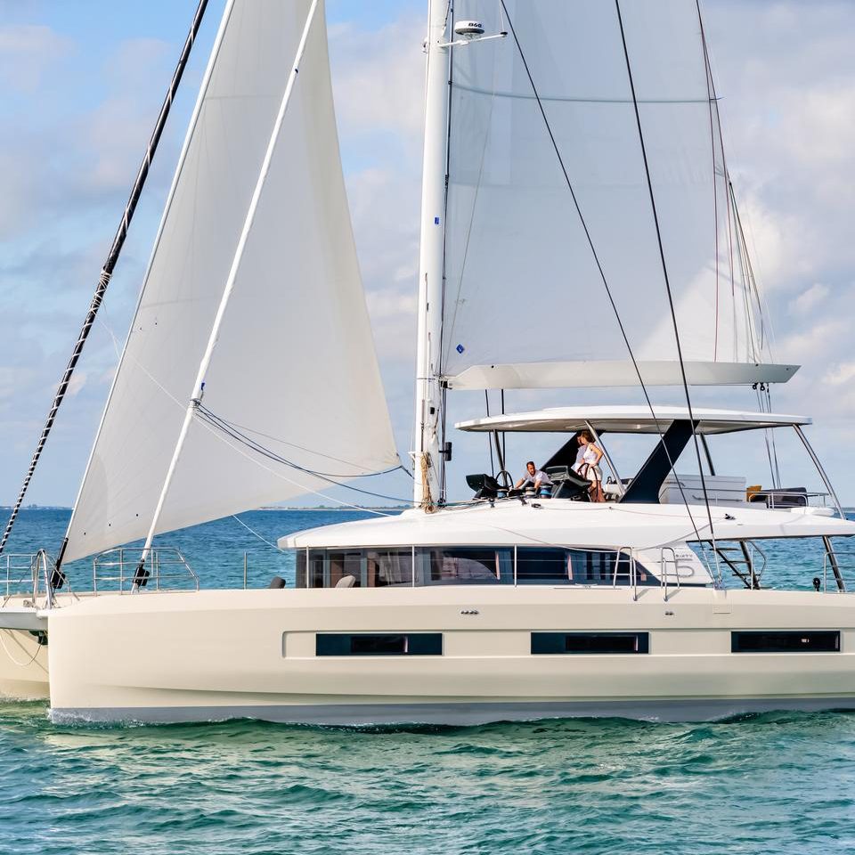 Lagoon Sixty 5 sailing with a couple at the helm