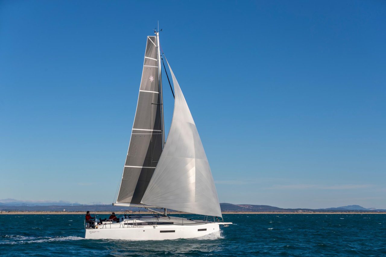Side view of the Sun Odyssey 380 sailing with a man at the helm