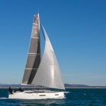 Side view of the Sun Odyssey 380 sailing with a man at the helm