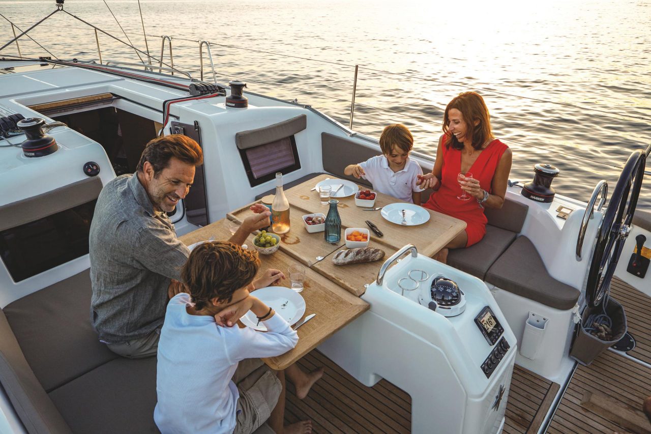 Family having dinner on the Sun Odyssey 410 cockpit