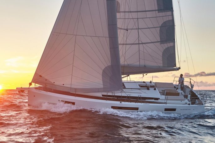 Side view of the Sun Odyssey 440 sailing with a man at the helm