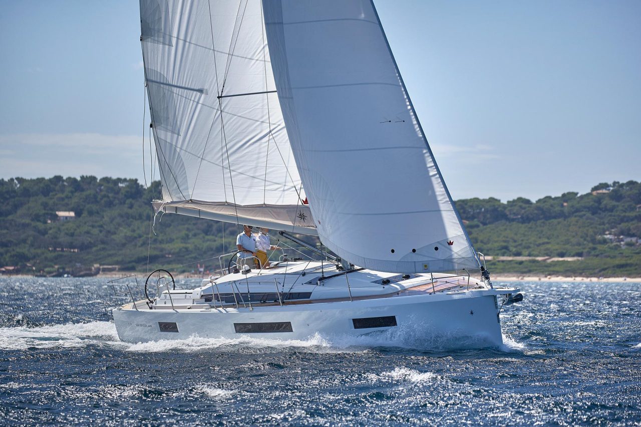 Jeanneau Sun Odyssey 440 sailing with a man and a woman at the helm