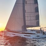 Side view of the Sun Odyssey 440 sailing with a man at the helm
