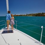 Children at the bow of the Jeanneau Sun Odyssey 490 sailing monohull