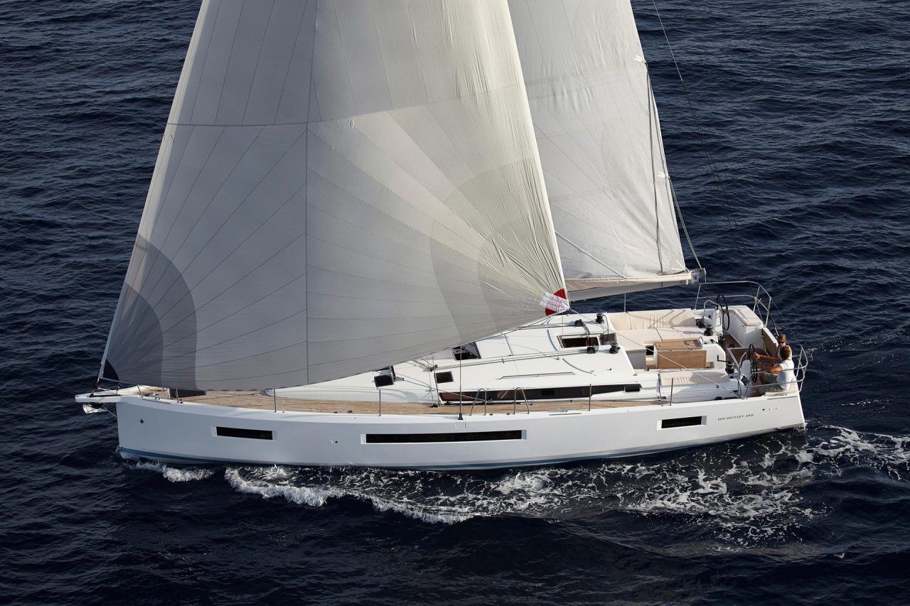 Aerial view of the Jeanneau Sun Odyssey 490 sailing with a couple at the helm