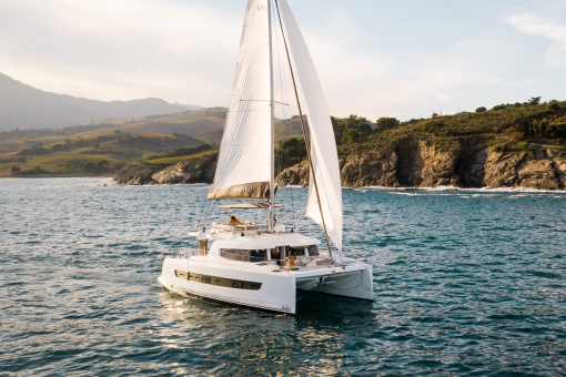 Bali 4.6 sailing with a woman at the helm and guests enjoying the foredeck