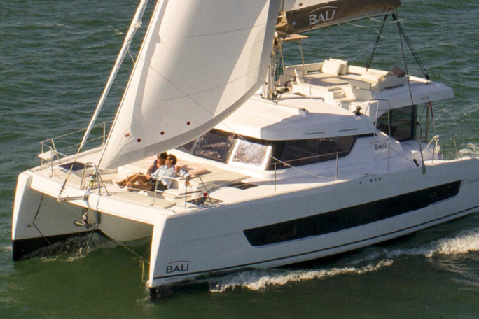 Bali Catspace sailing with guests enjoying the foredeck