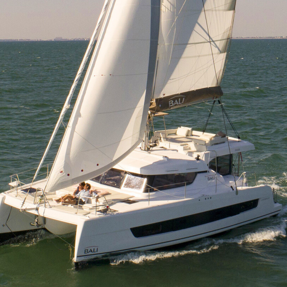 Bali Catspace sailing with guests enjoying the foredeck