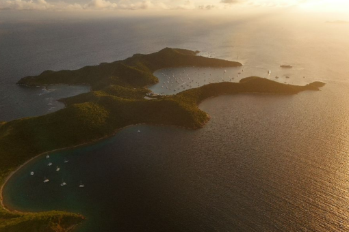 A distant drone view of a bay in the British Virgin Islands at sunset.